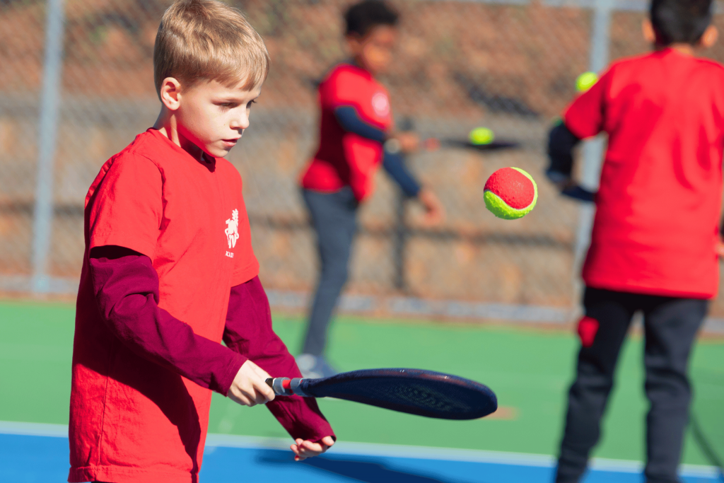 Child practicing tennis control indoors using SMART Start Bundle
