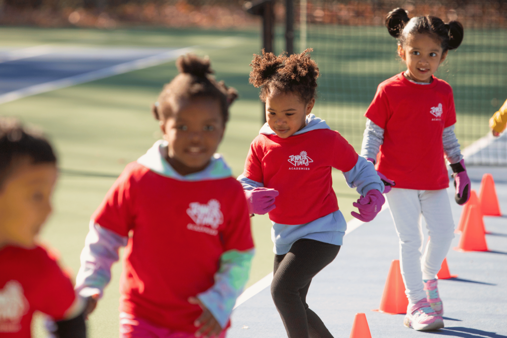 Young children participating in a Tennis Time Academies Little Bouncers class, focusing on fun, agility, and coordination exercises for kids aged 4-5 as part of an engaging tennis program.