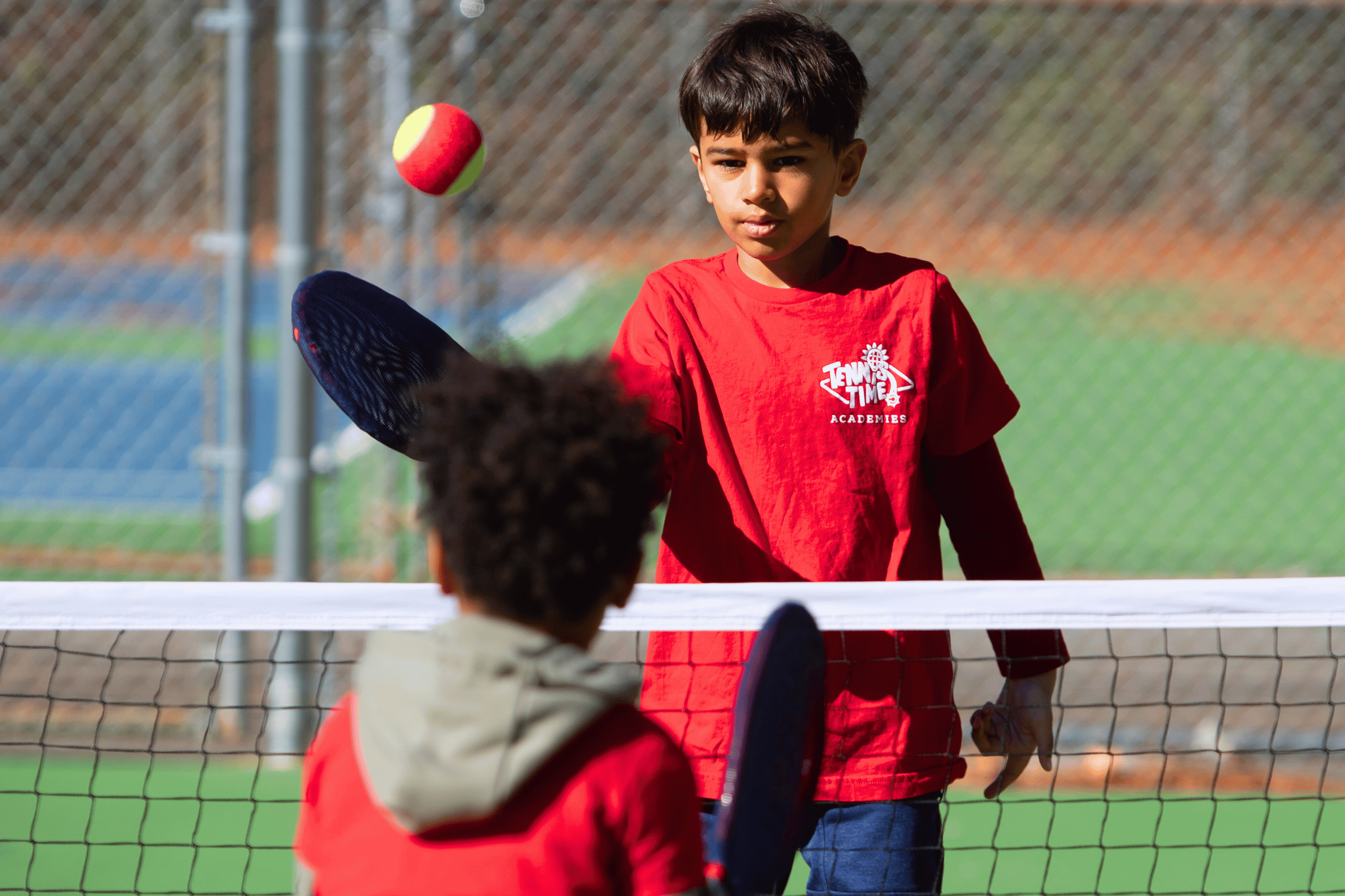 Child practicing tennis control indoors using SMART Start Bundle