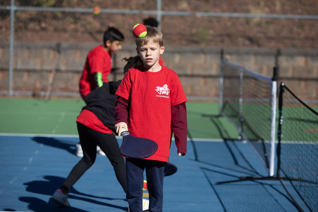 Child practicing tennis with SMART Racket at Tennis Time Academies