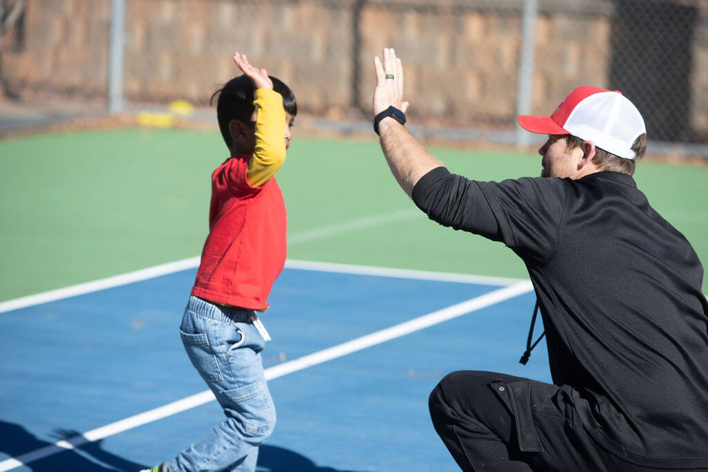 Coach high-fiving child