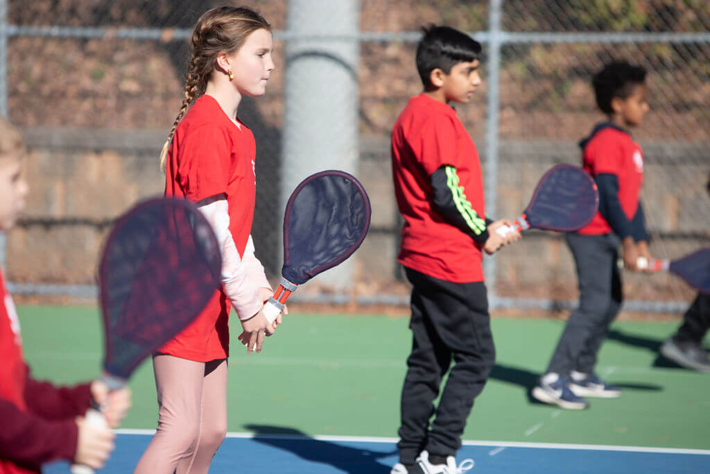 Young kids playing with SMART Rackets™ during a Tennis Time Academies class