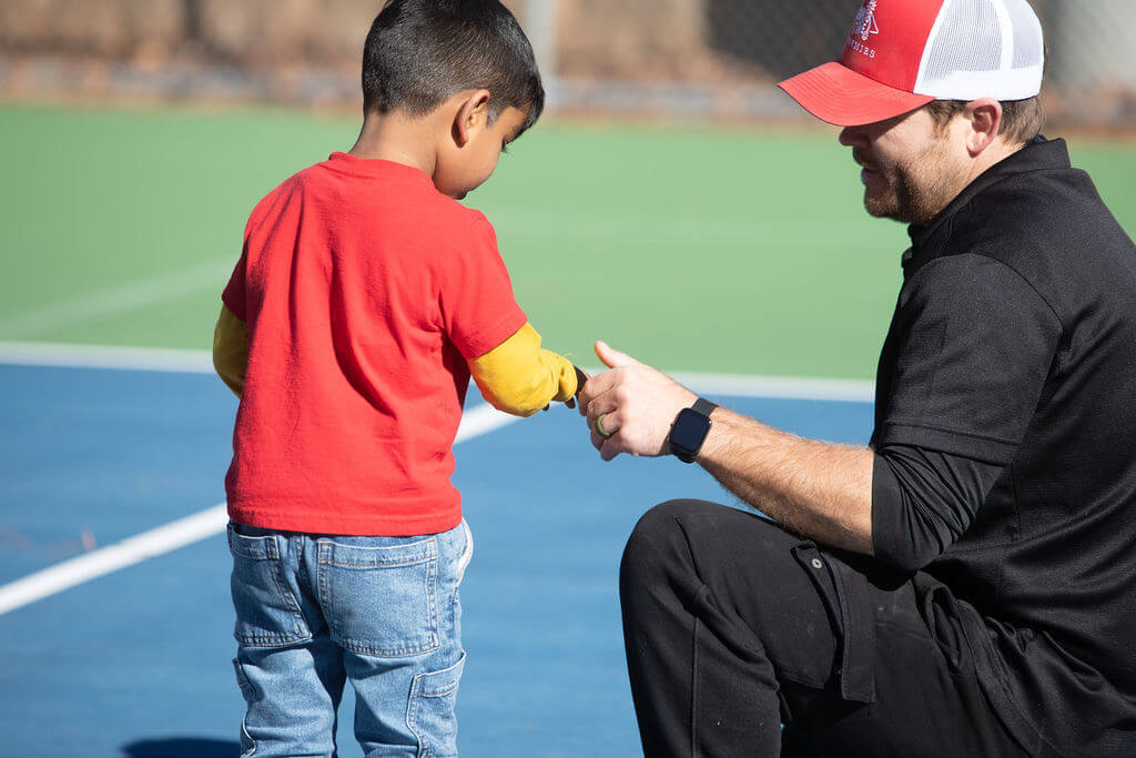 kid smiling with coach