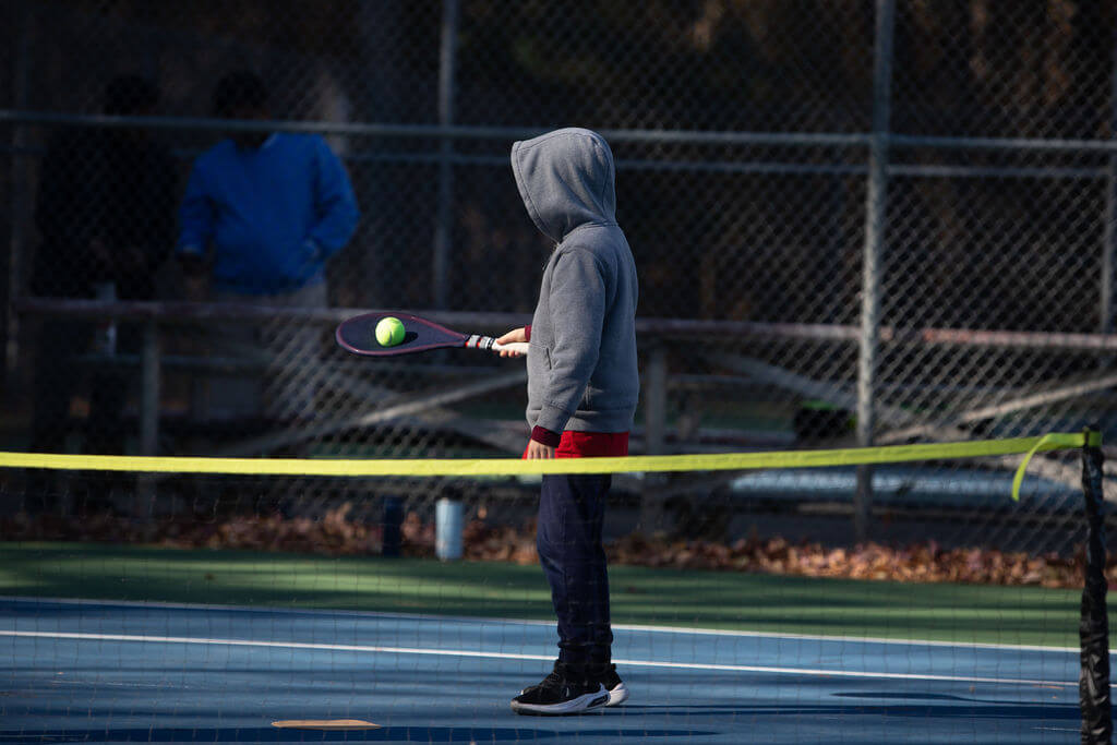 a boy playing tennis