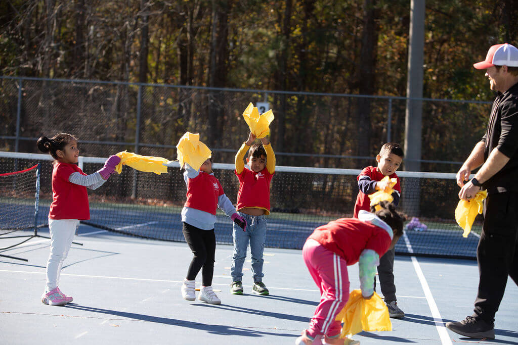 Young beginner learning tennis with scaled SMART Tennis tools