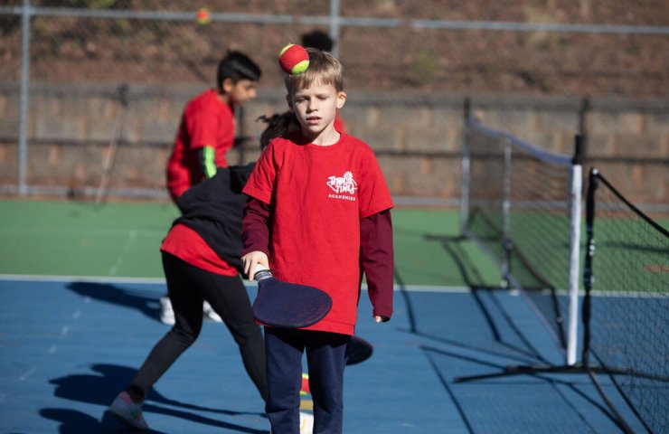 Child practicing tennis with SMART Racket at Tennis Time Academies