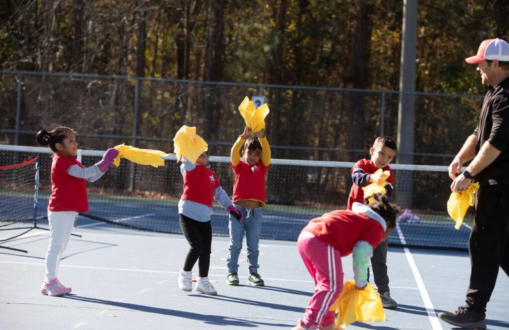 Young beginner learning tennis with scaled SMART Tennis tools
