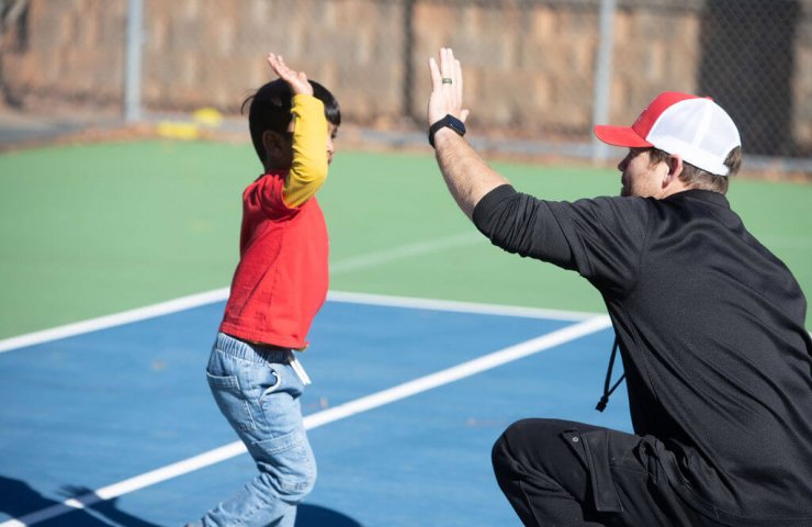 Coach high-fiving child