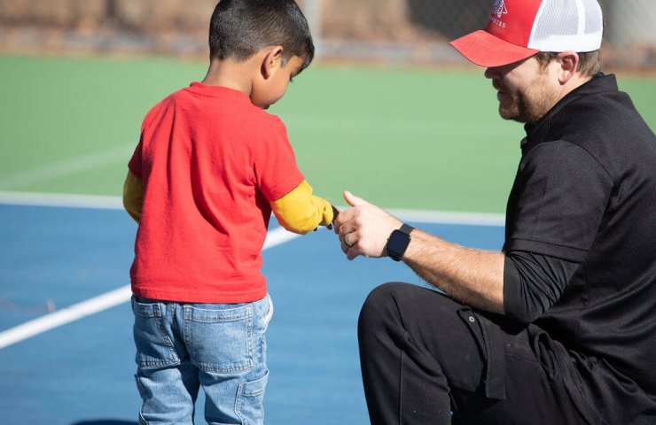 kid smiling with coach