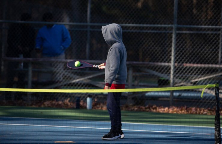 a boy playing tennis