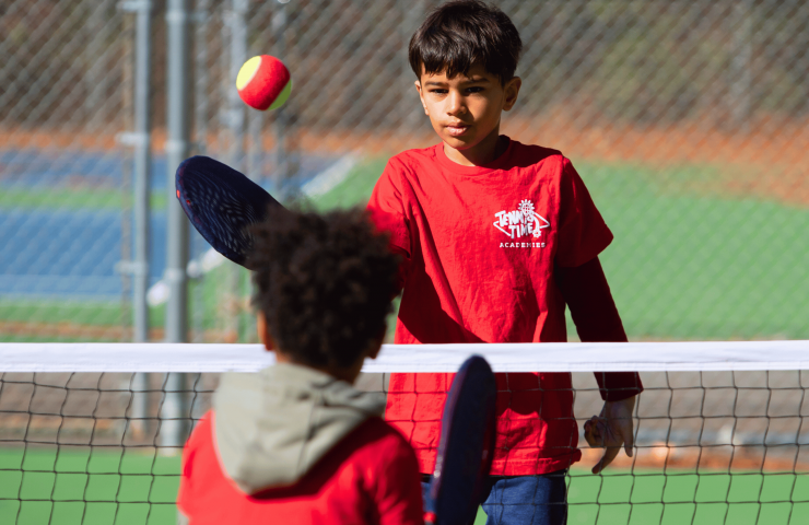 Child practicing tennis control indoors using SMART Start Bundle